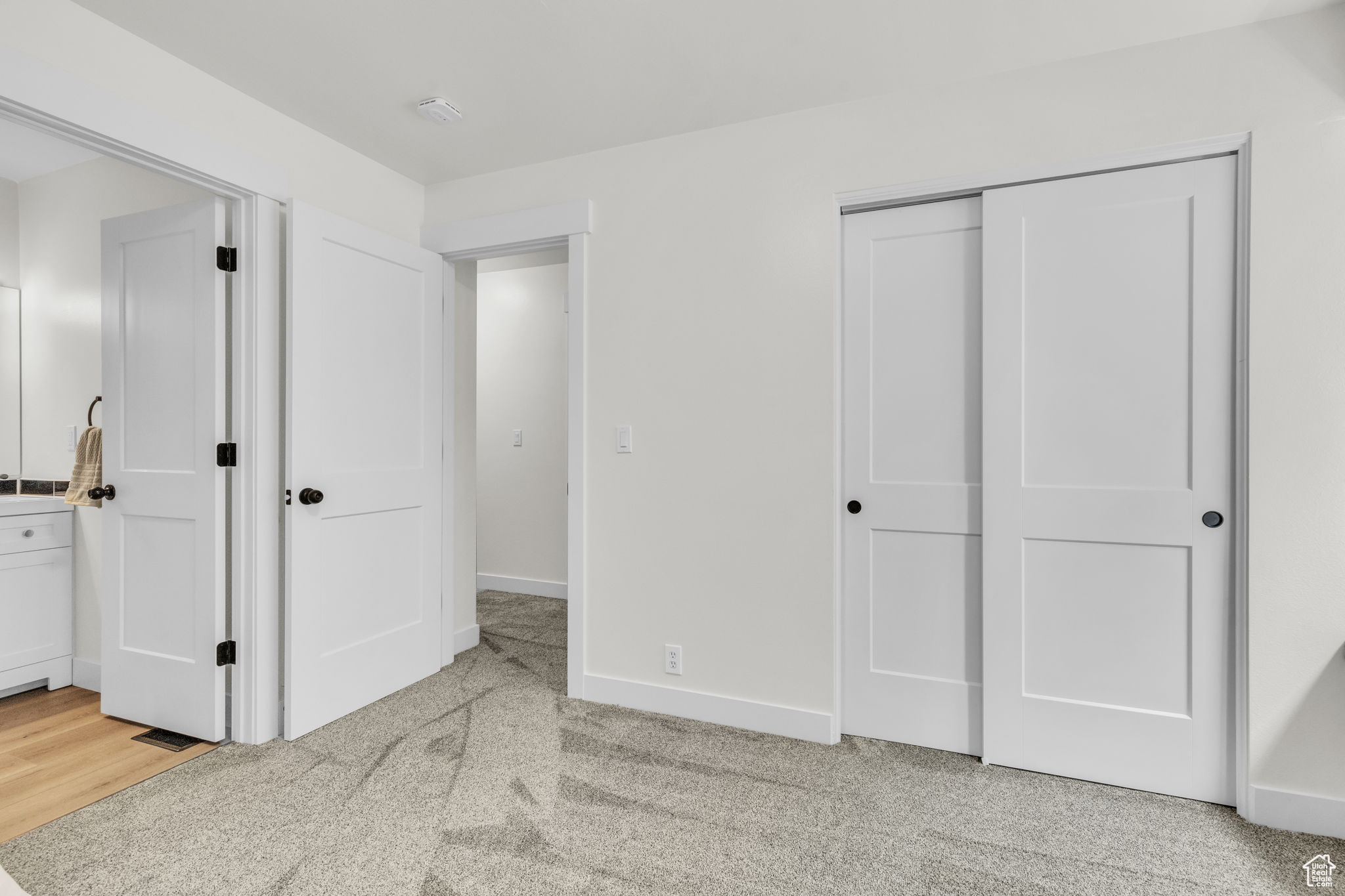 Carpeted bedroom featuring a closet