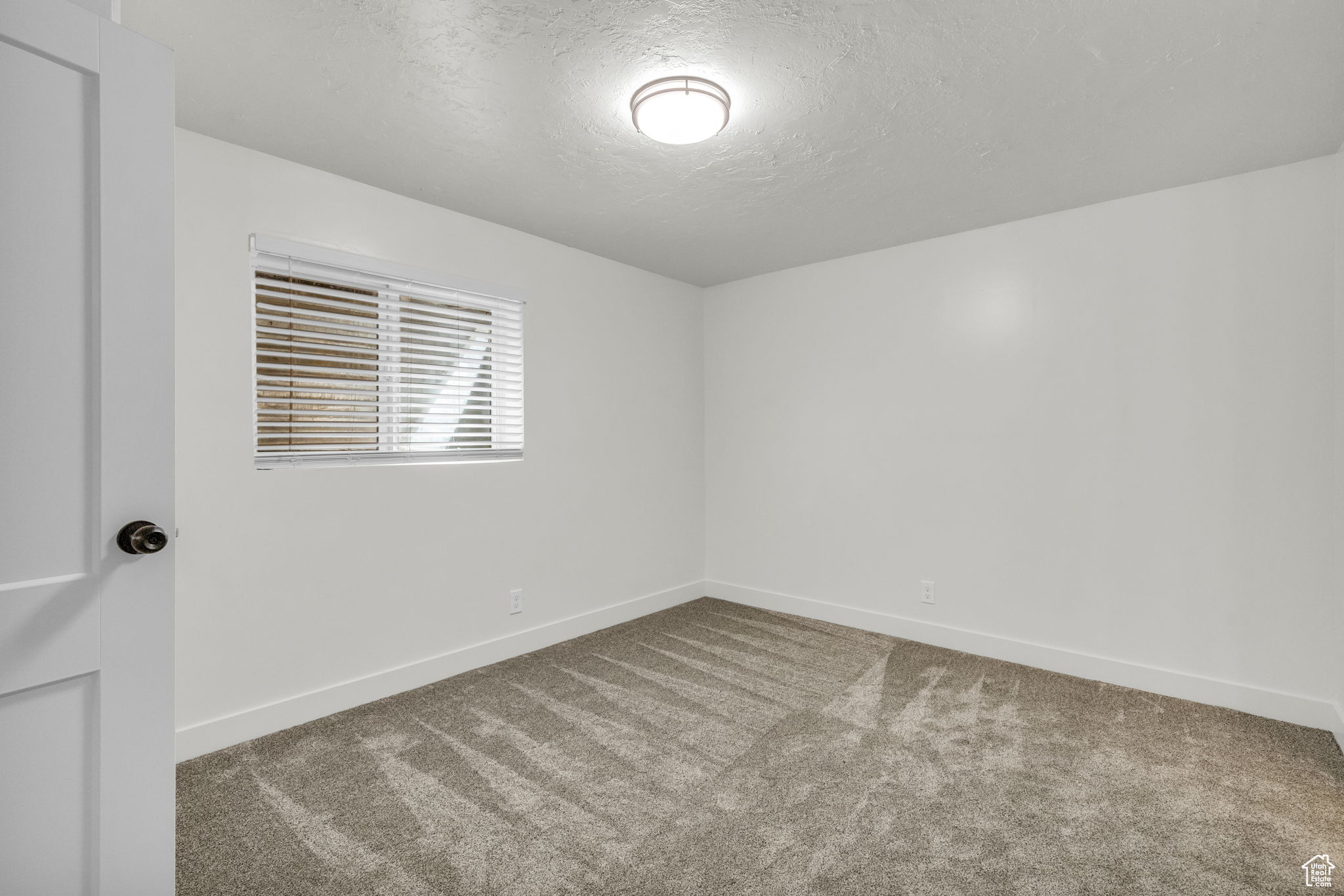 Empty room featuring dark carpet