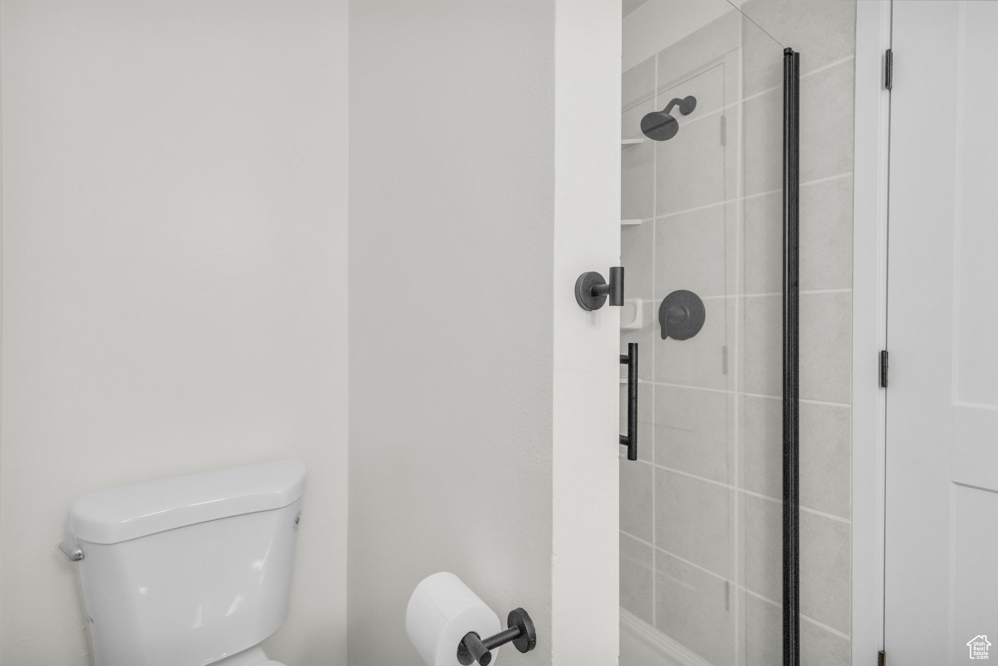 Bathroom with a shower with shower door and toilet