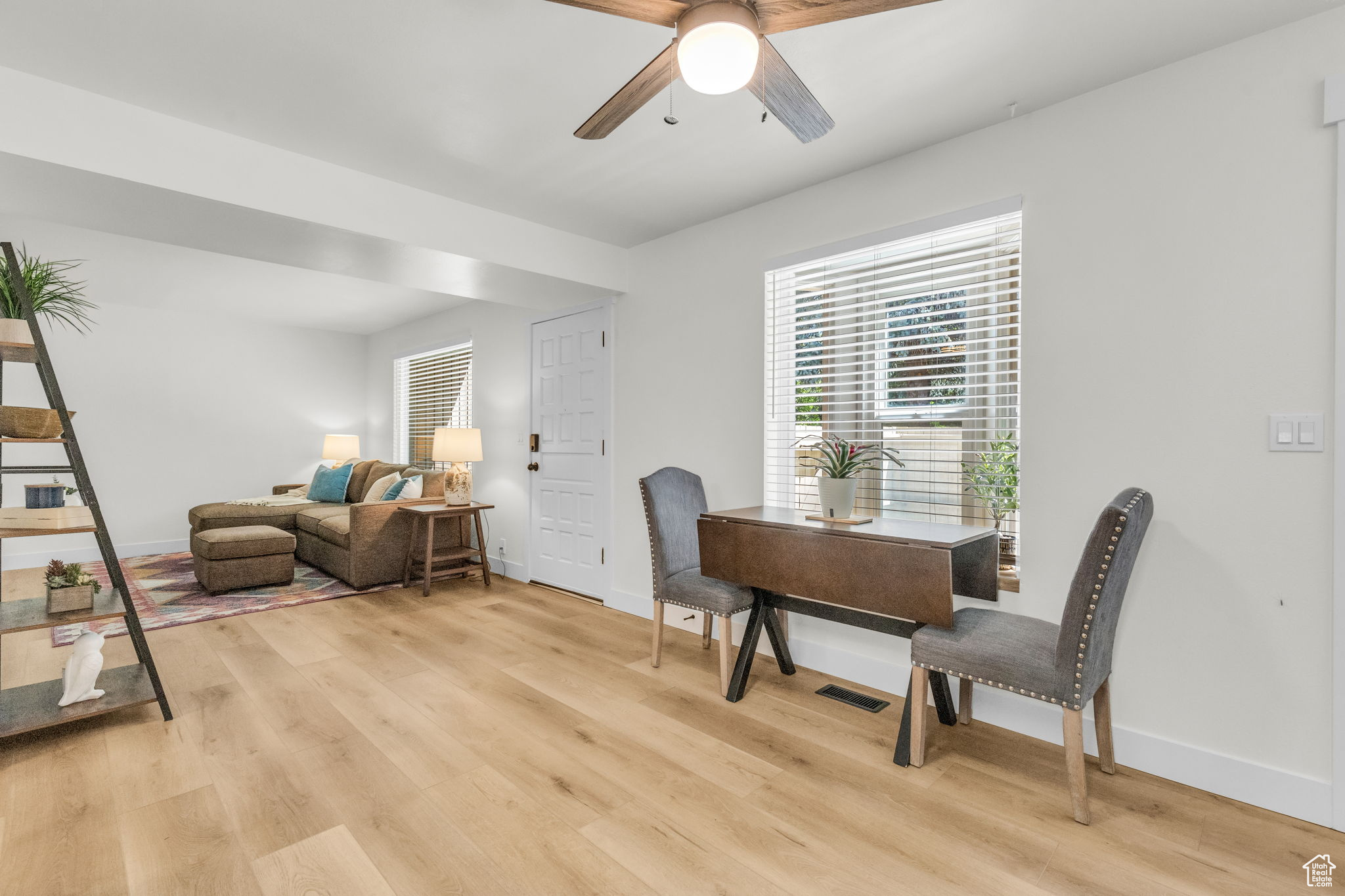 Dining room featuring ceiling fan and light hardwood / wood-style flooring