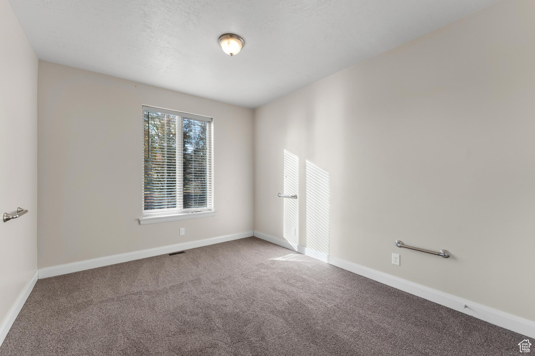 Spare bedroom featuring carpet flooring