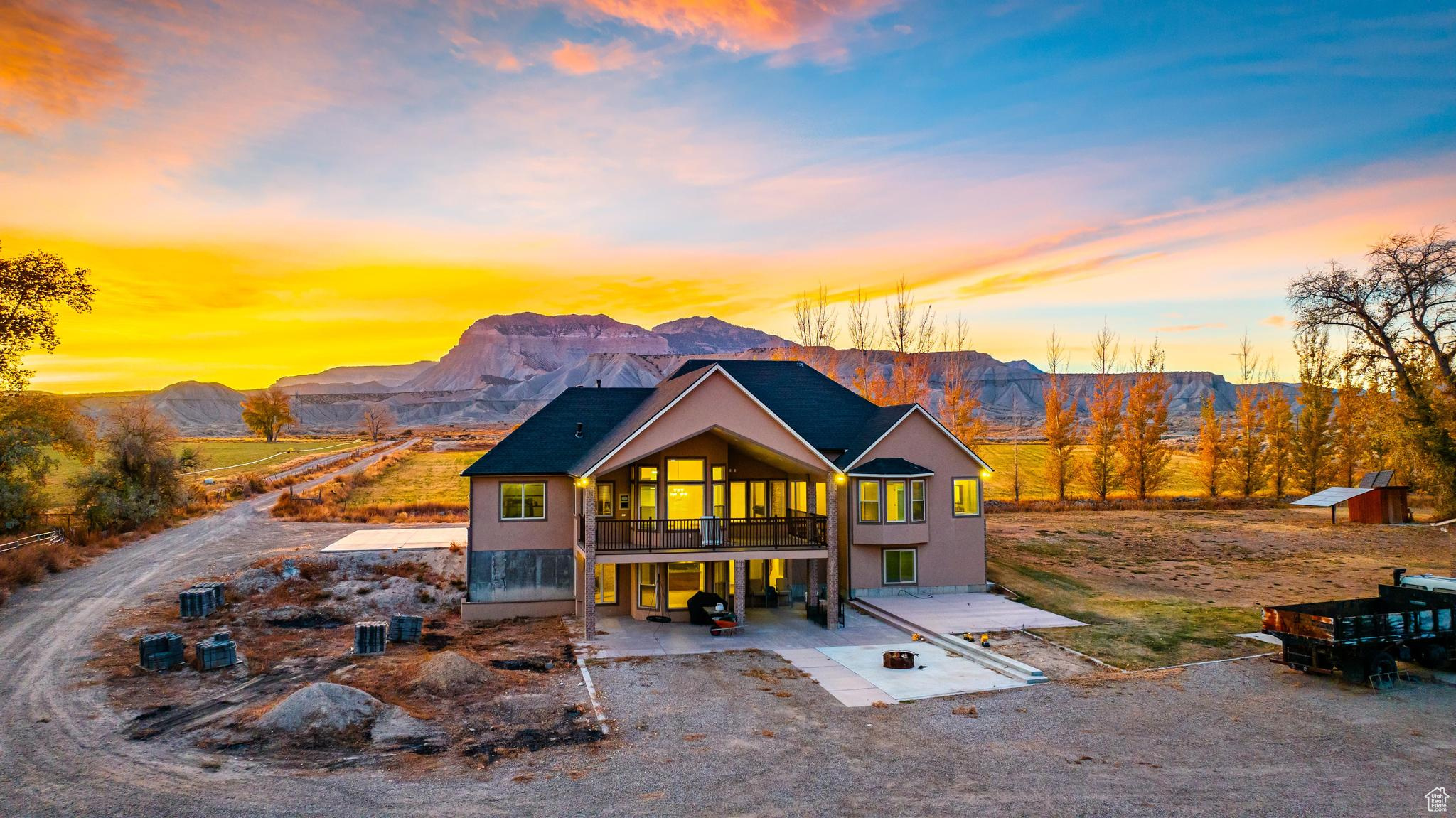 View of back of home with a balcony and a mountain view