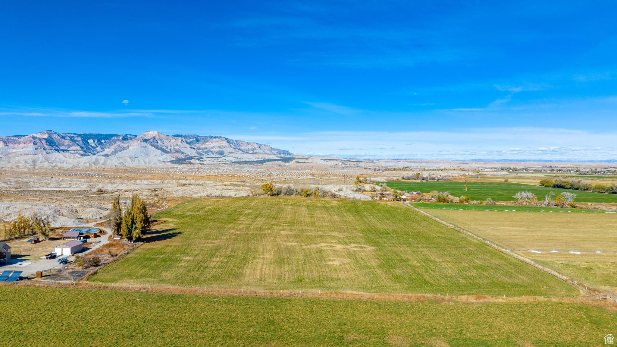 Aerial view with a mountain view and a rural view.  Working farm alpha hay parcel.