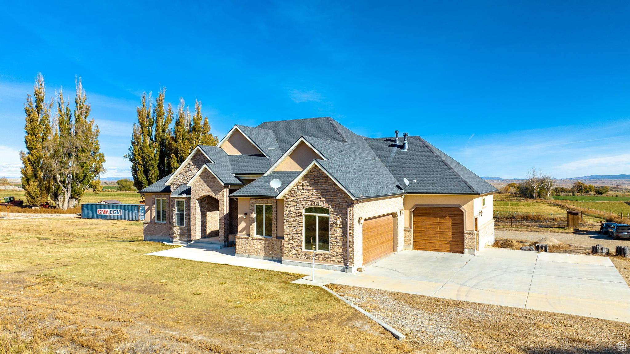 View of front of property featuring a large 4 car garage