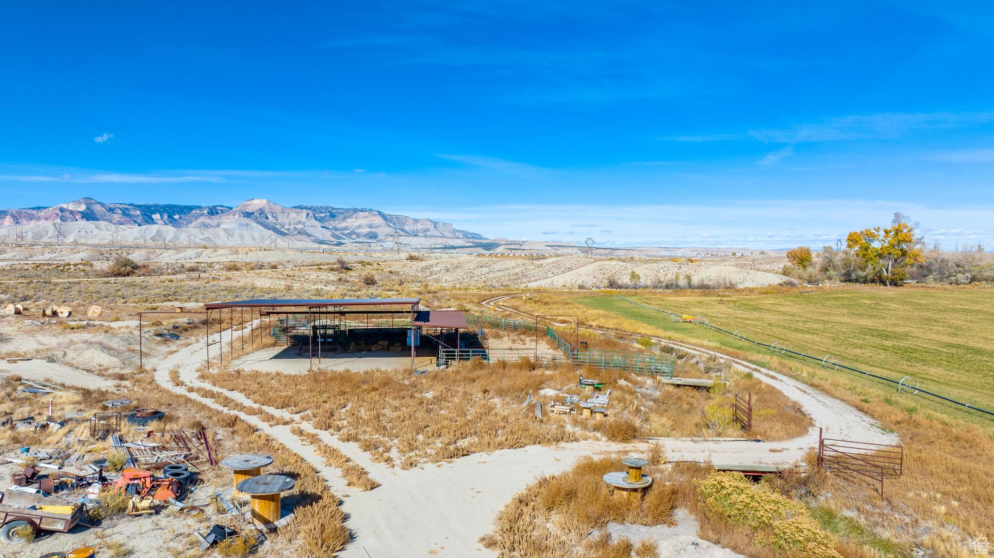 Aerial view featuring a rural view and a mountain view.  Storage area for hay.