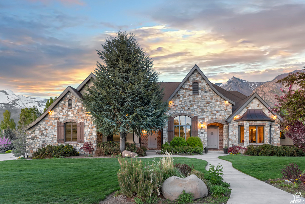 View of front facade featuring a mountain view and a lawn