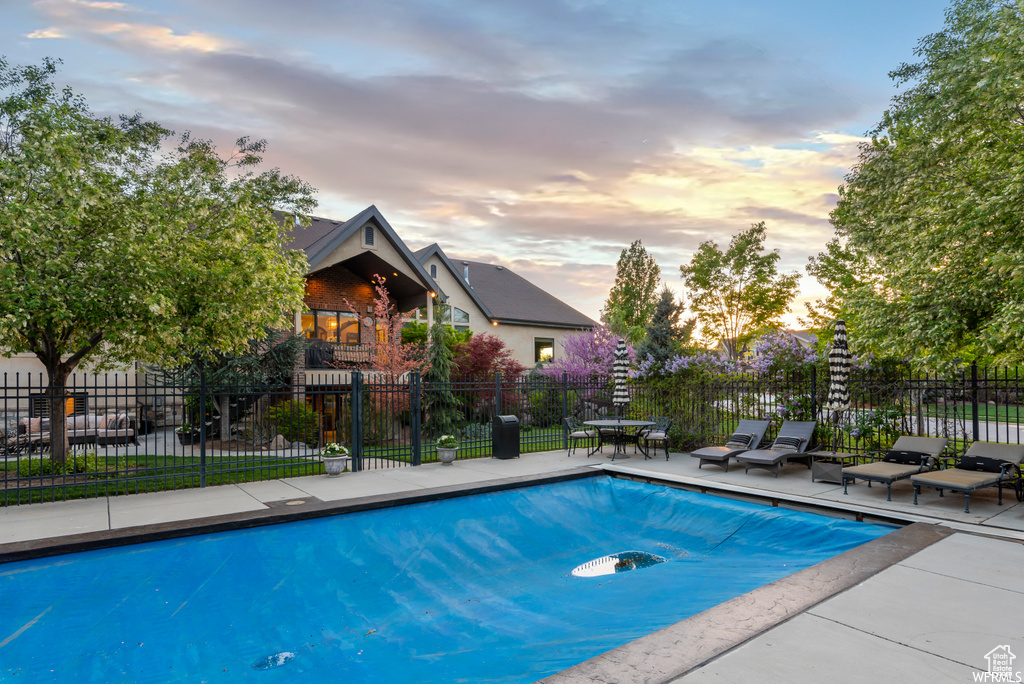 View of pool at dusk