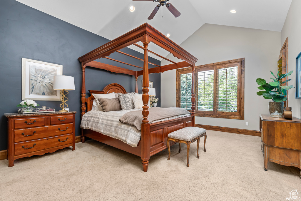 Carpeted bedroom featuring ceiling fan and vaulted ceiling