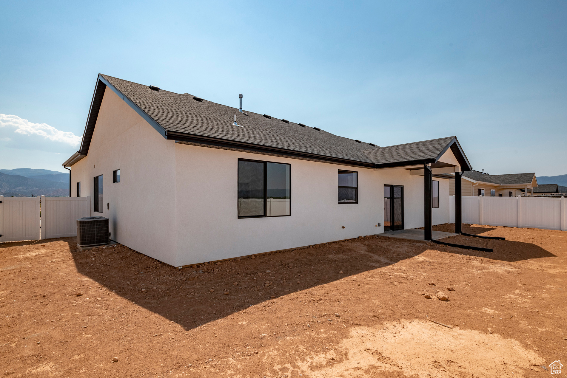 Rear view of property featuring central AC