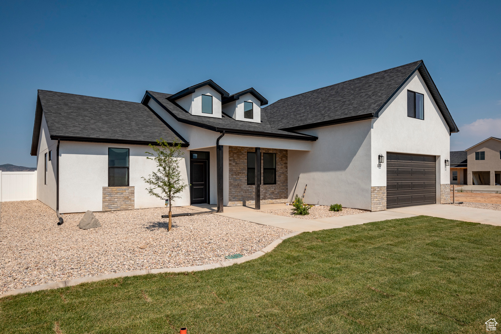 View of front of house with a garage and a front lawn