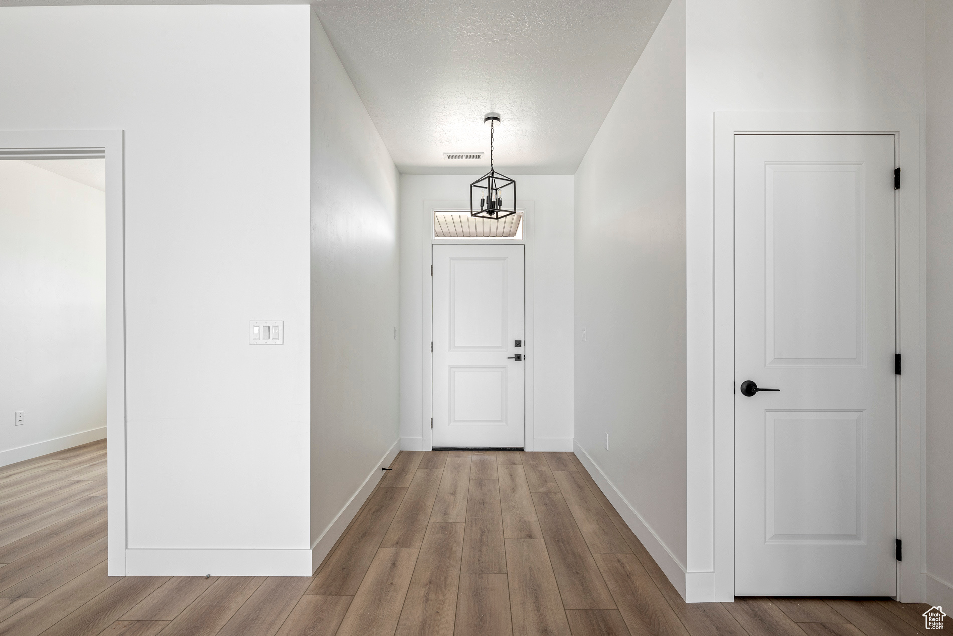 Corridor featuring light wood-type flooring