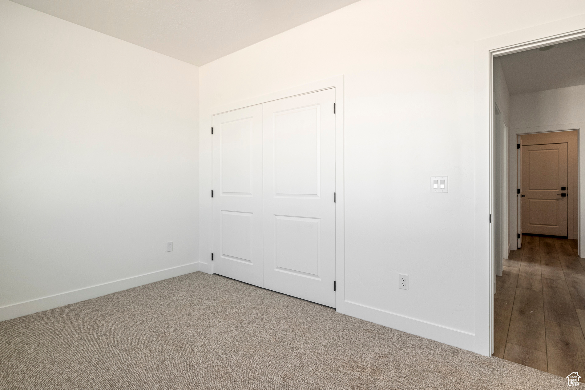 Unfurnished bedroom with carpet and a closet