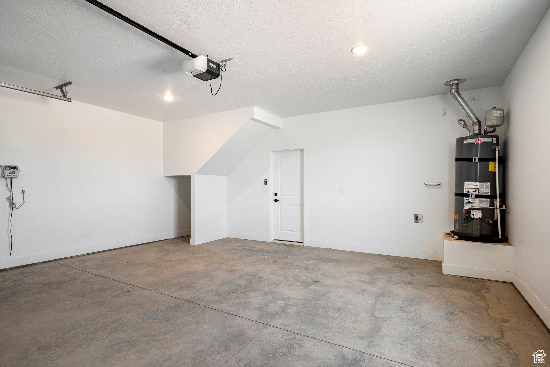 Garage with a garage door opener and water heater