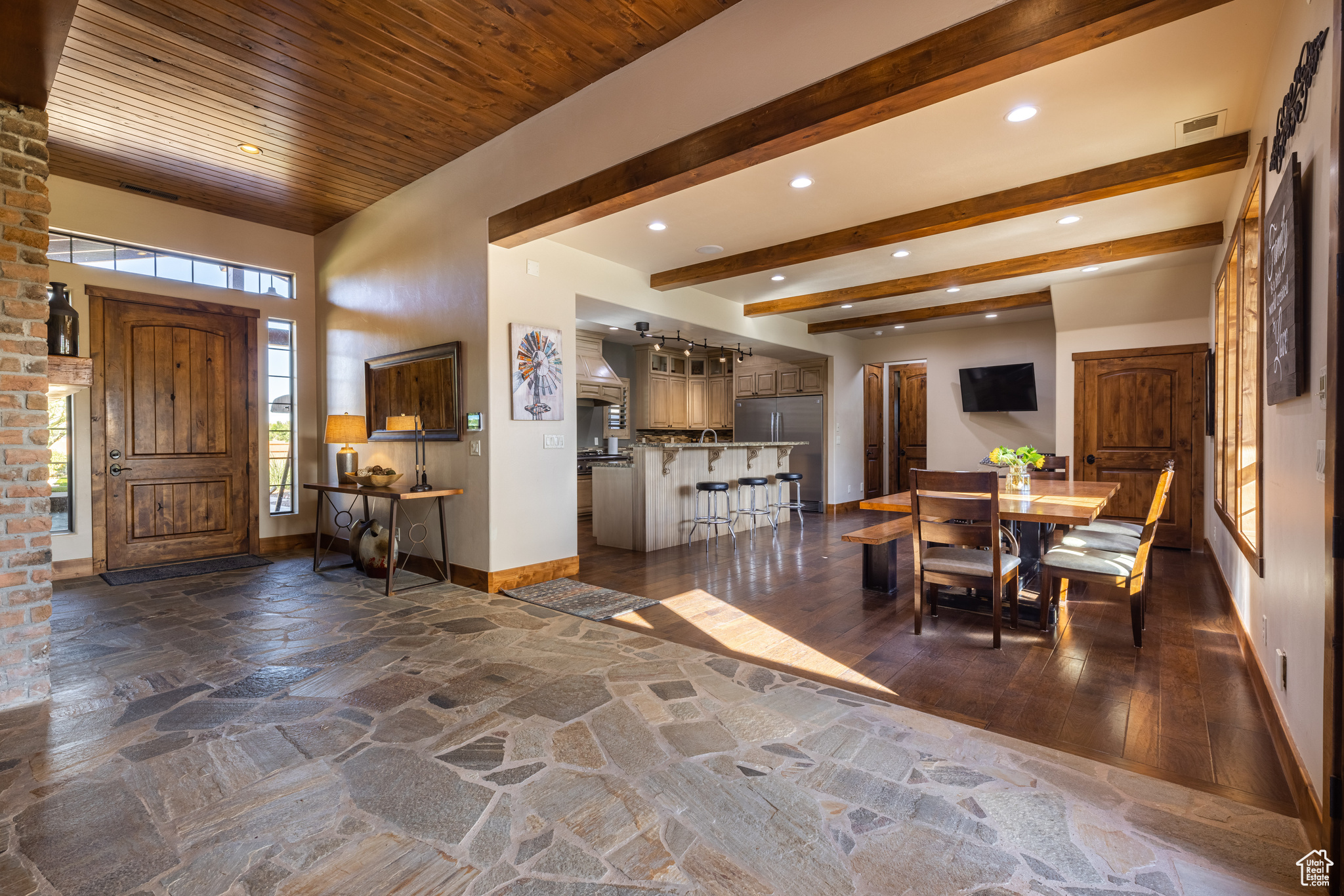 Foyer featuring  the hand hewn slate flooring as well as dark hardwood style flooring in the kitchen and dining area.
