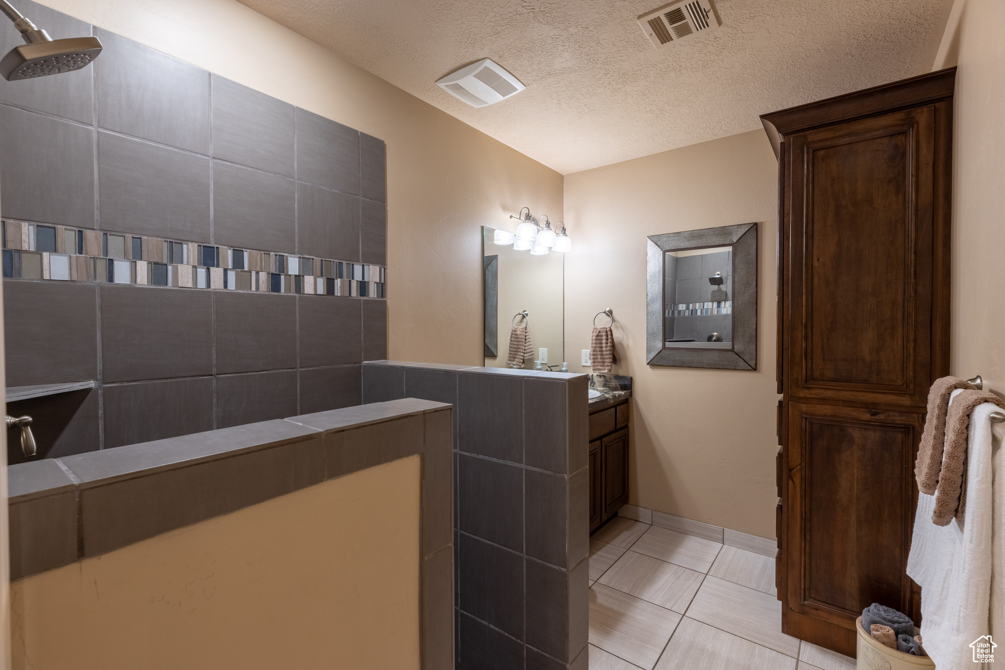 2nd Bathroom w/adjacent bedroom and media room featuring tile floors, vanity