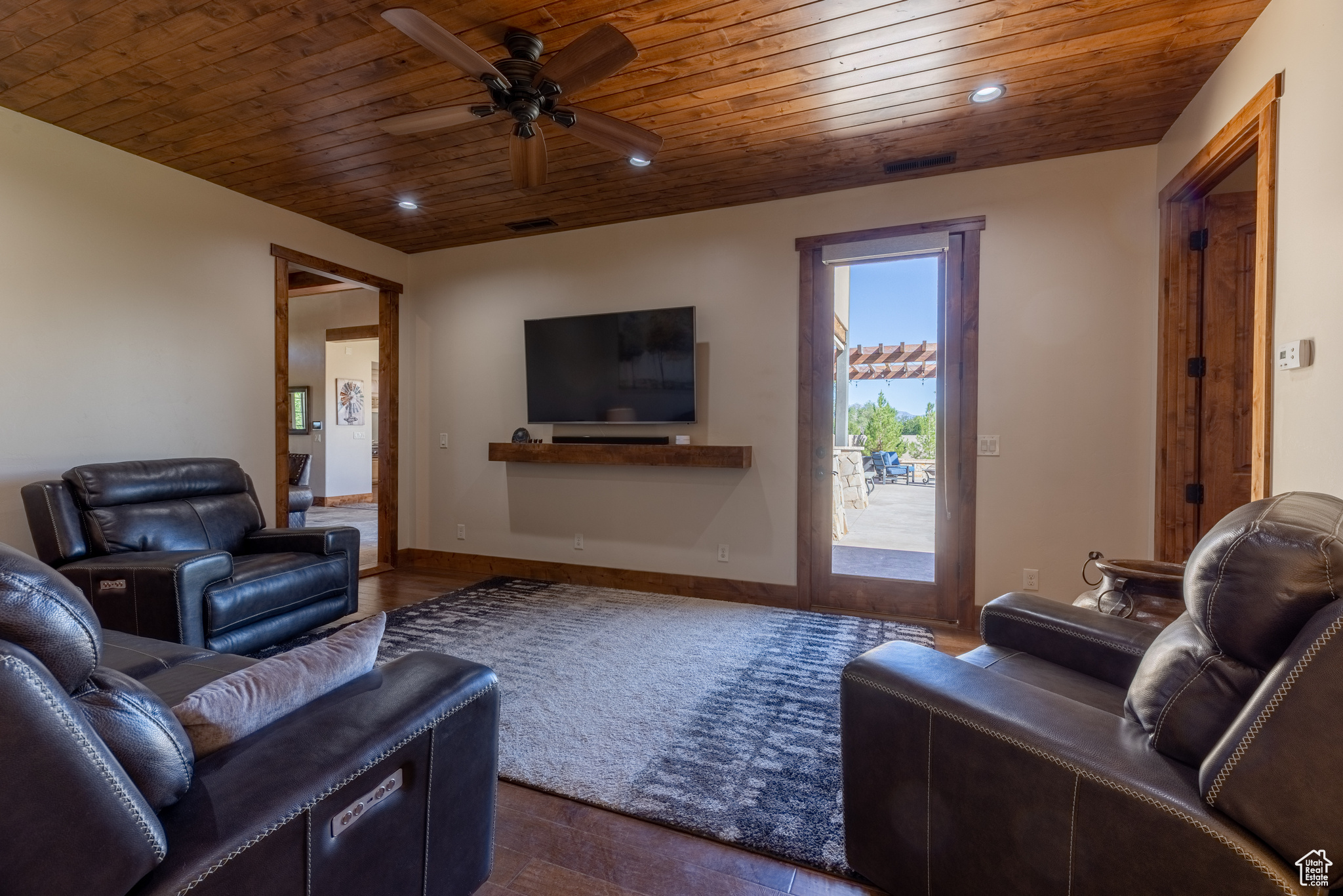 Living room featuring wooden ceiling, dark hardwood / wood floors, and ceiling fan