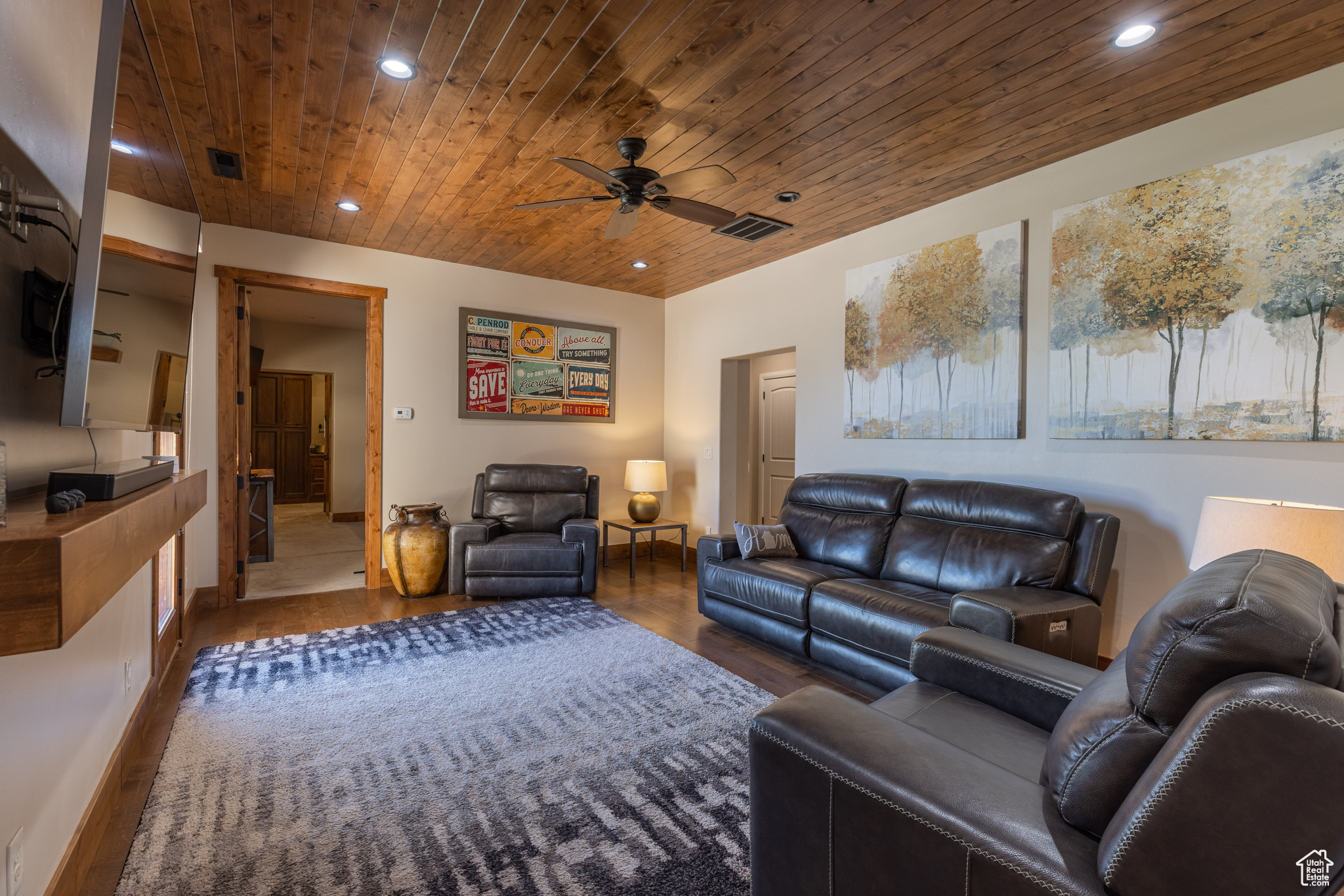 Media room with ceiling fan, dark hardwood / wood-floors, and wooden ceiling accent