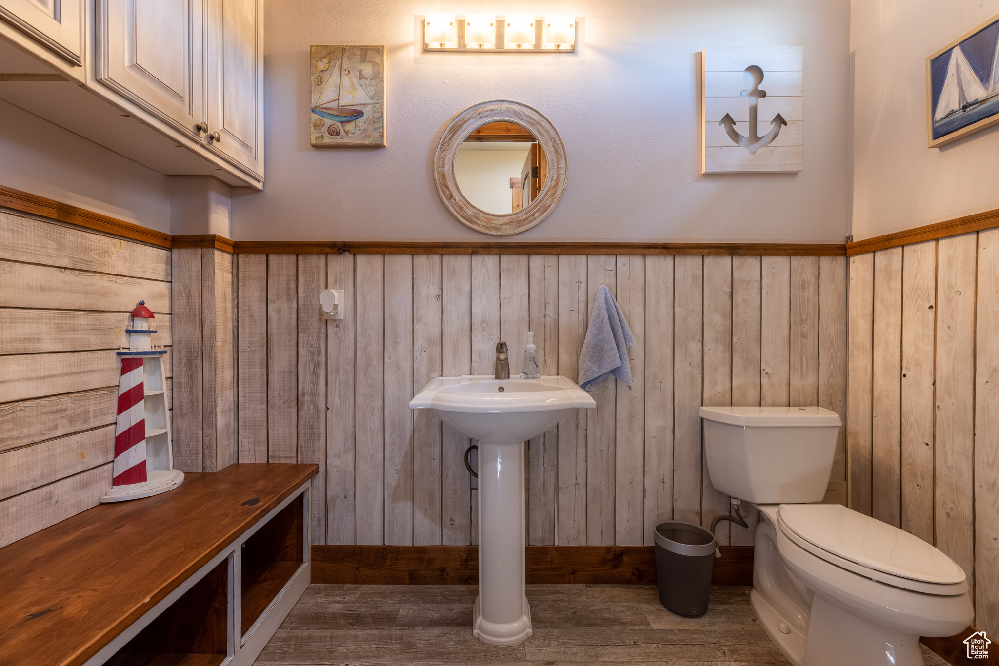 Powder room Bathroom with hardwood / wood-style flooring, toilet, & custom wooden wall treatments