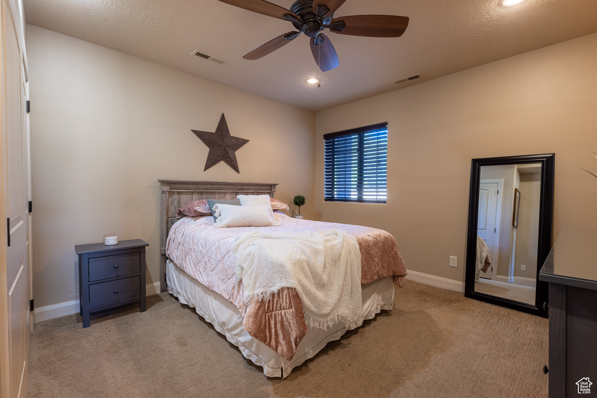 3rd Bedroom with ceiling fan and light carpet w/bathroom adjacent