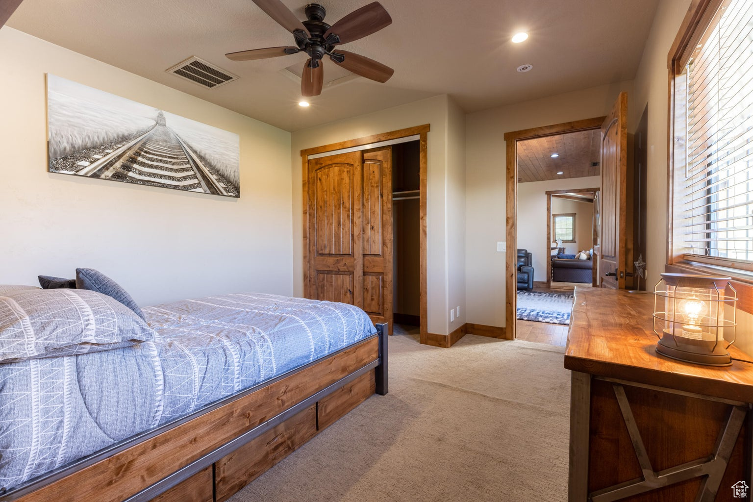 Bedroom featuring ceiling fan, a closet, and carpet floors