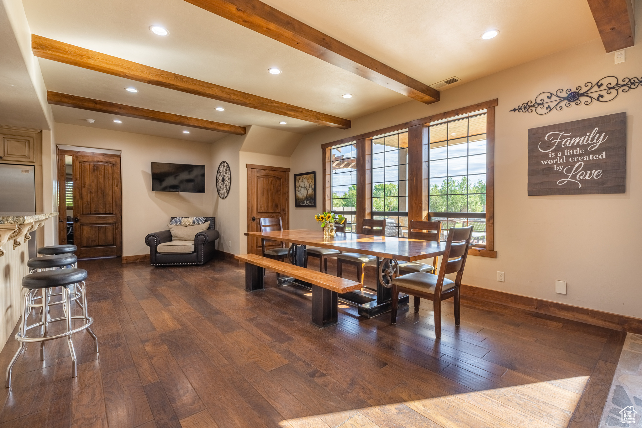Dining space featuring beam ceiling and dark hardwood / wood-style floors