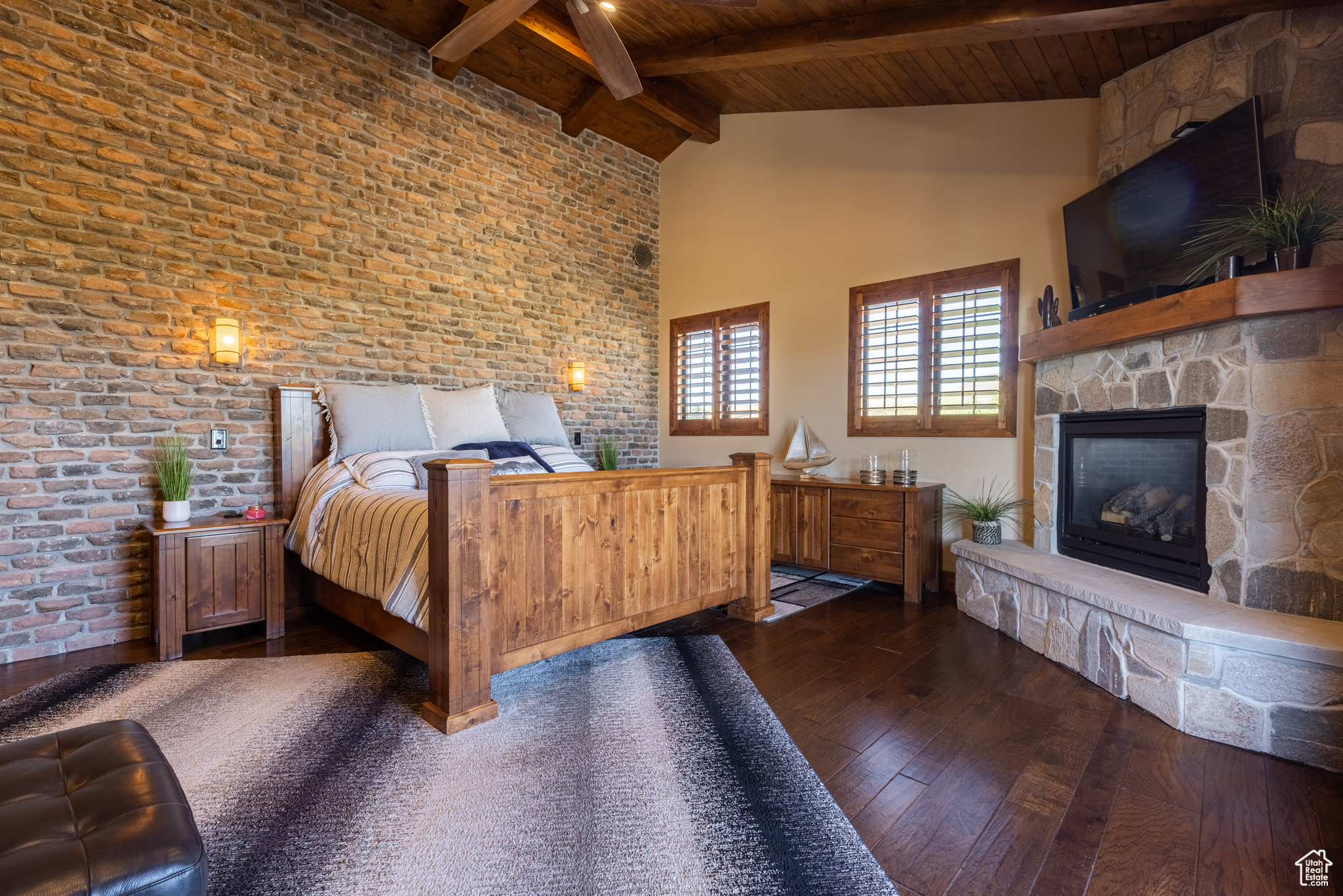 Principle Bedroom suite 2nd view with a stone fireplace, high vaulted ceiling, beam ceiling, dark hardwood / wood-style floors, and wooden ceiling