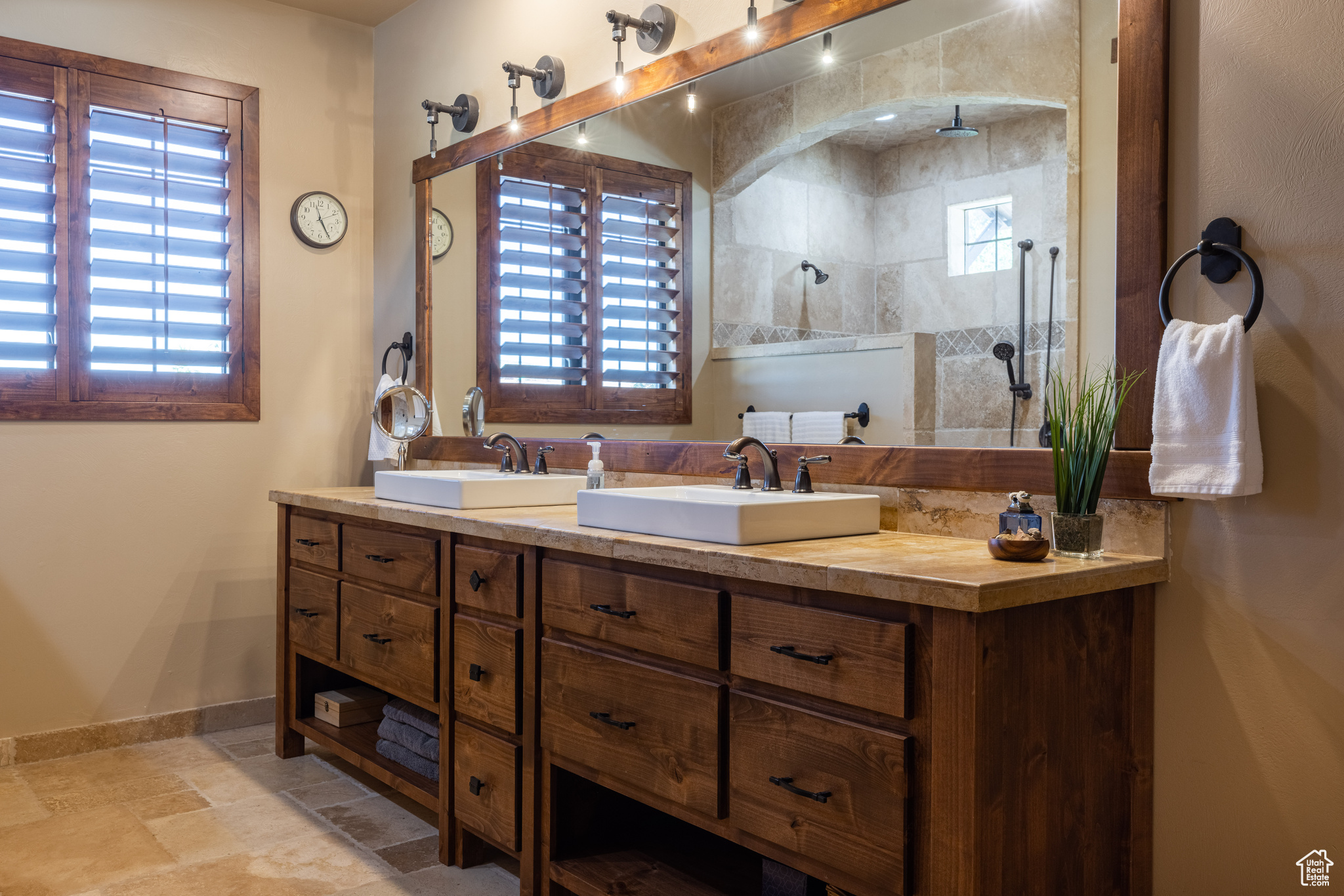 Principle suite Bathroom featuring tile floors, dual bowl vanity, and a tile shower