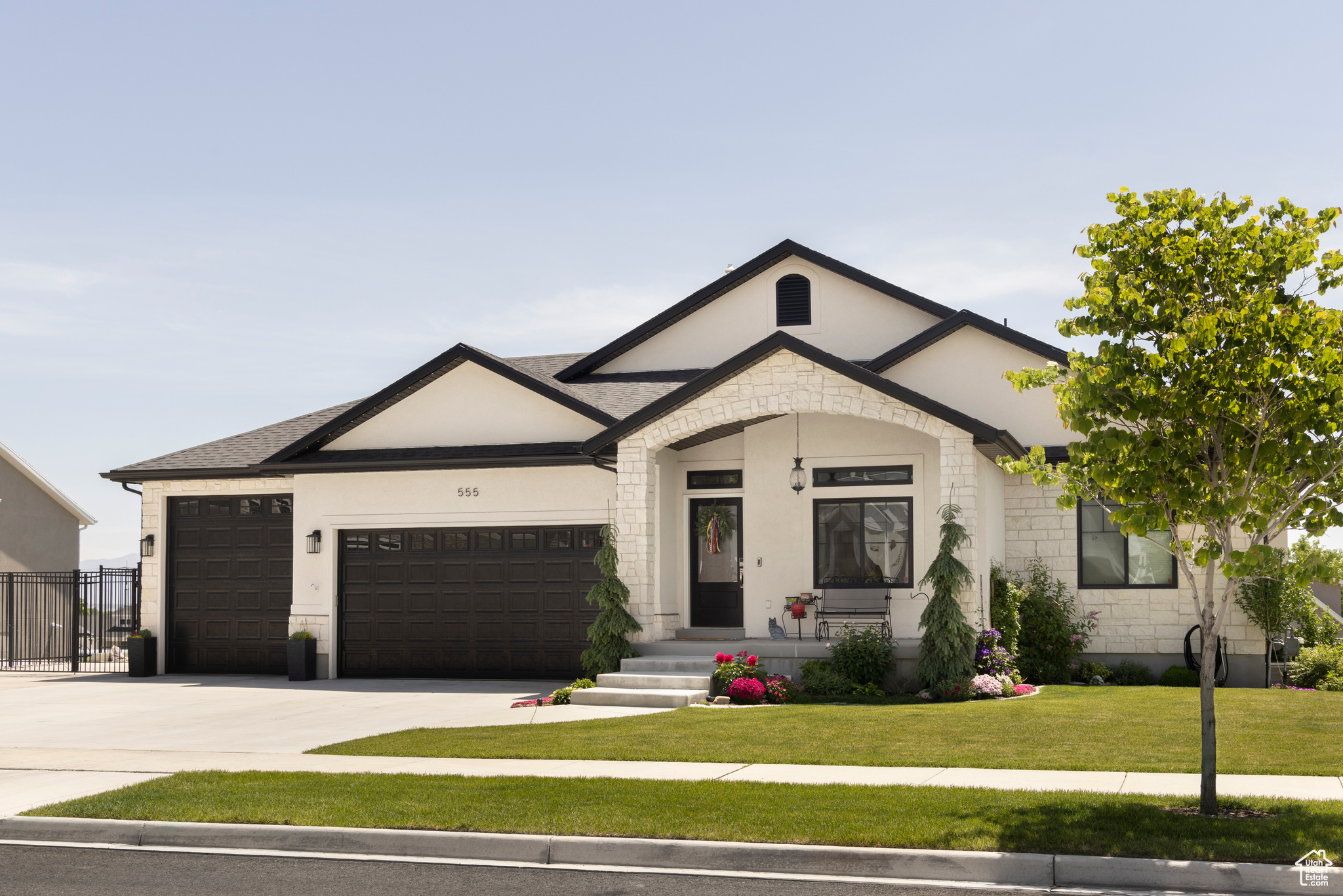 View of front of home featuring a garage and a front lawn