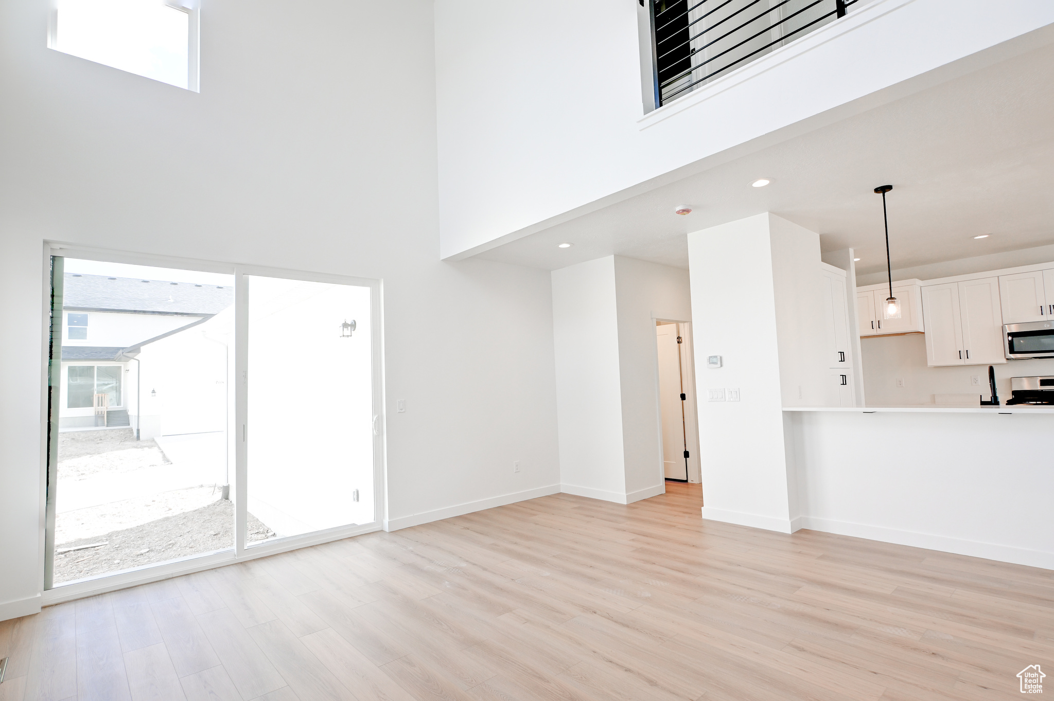 showing backyard access and hallway to garage and half bath.