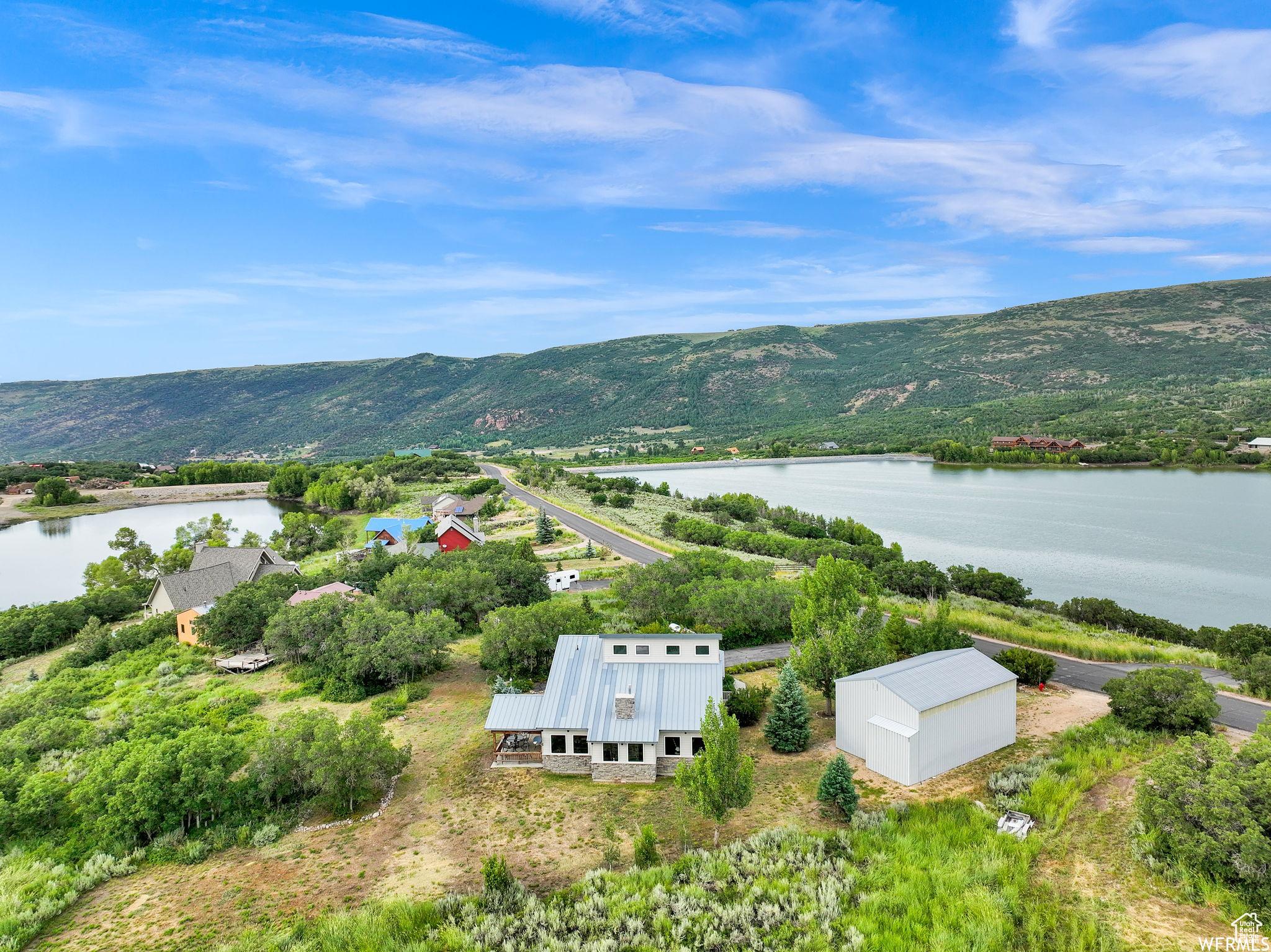 Drone / aerial view with a water and mountain view