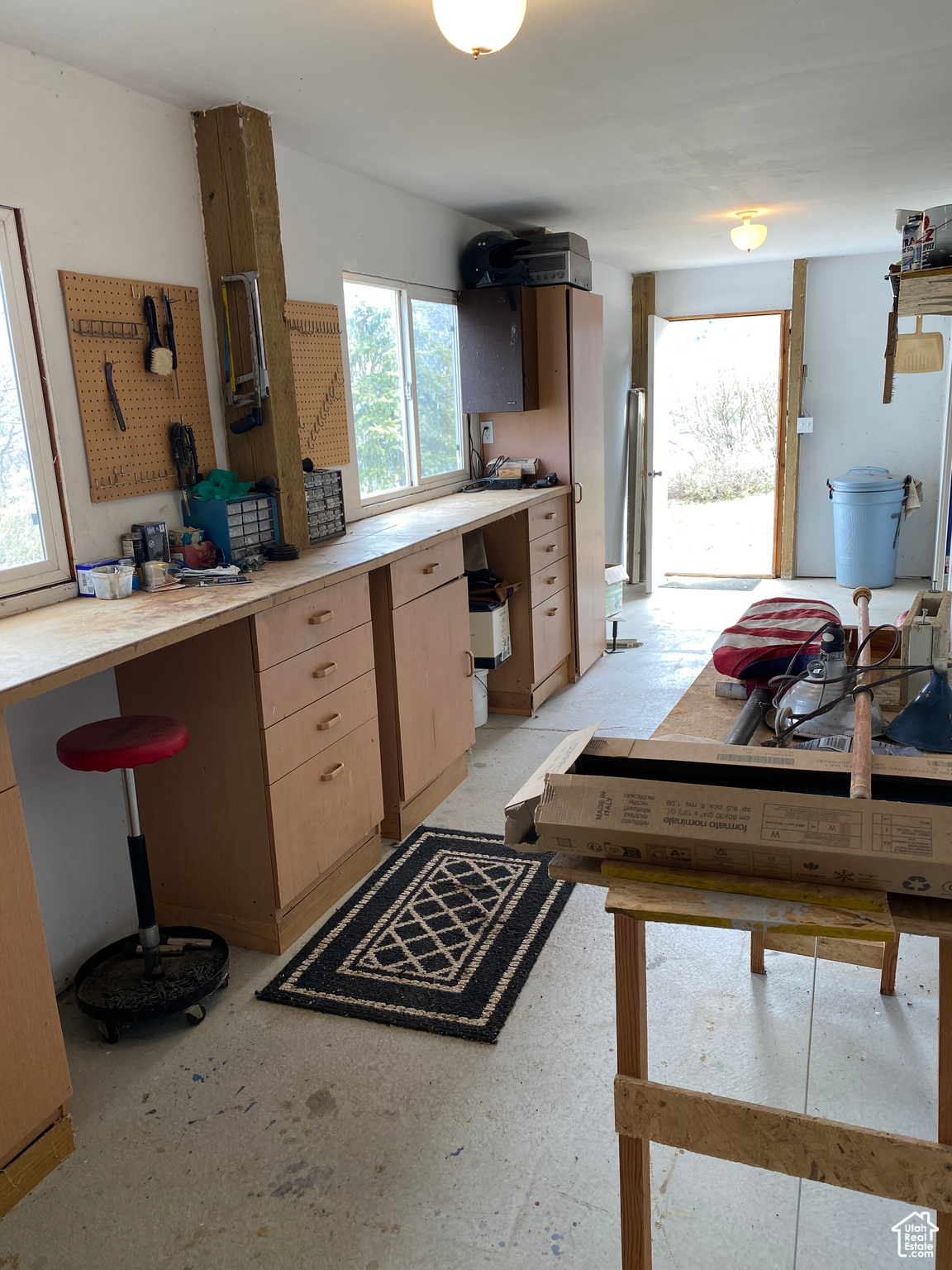 Workshop featuring light brown cabinetry