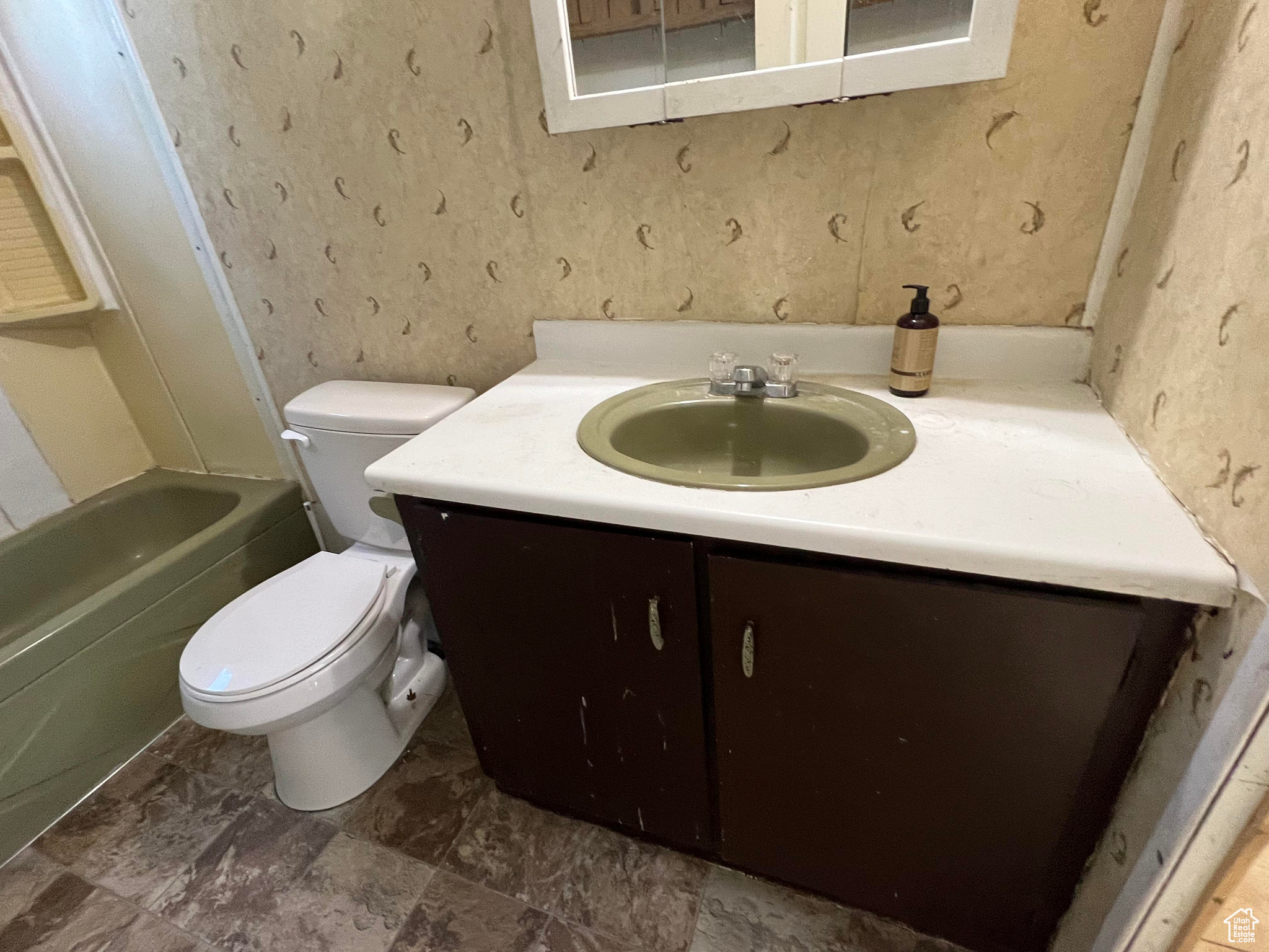 Full bathroom with tile flooring, vanity, toilet, and bathtub / shower combination