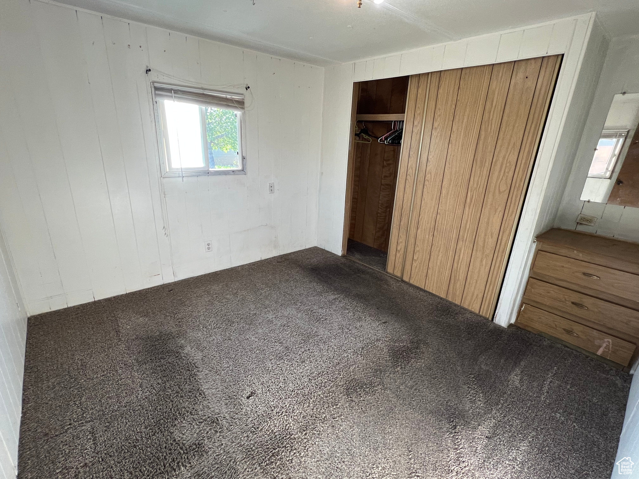 Unfurnished bedroom with a closet and carpet floors