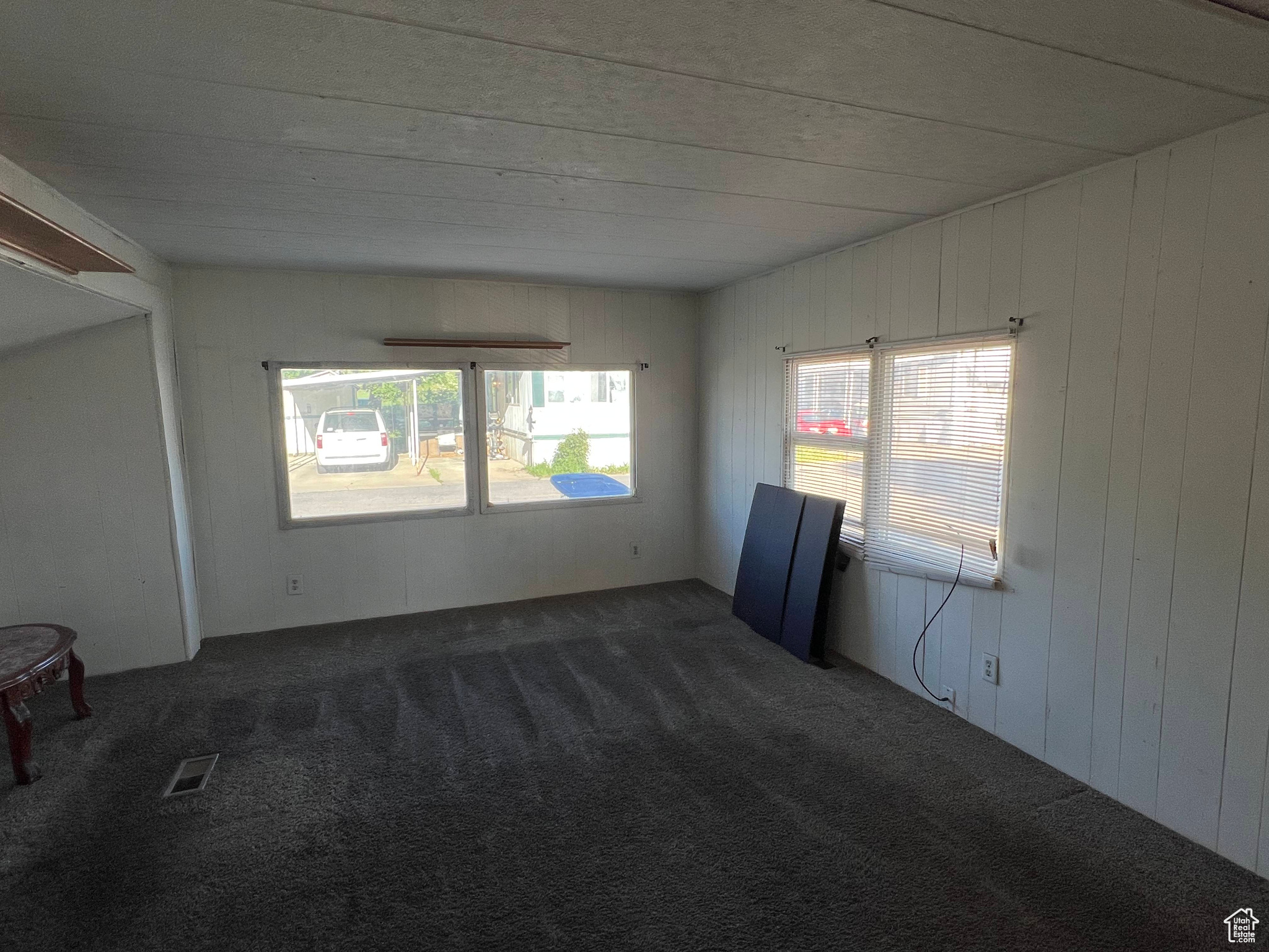 Unfurnished room with dark colored carpet