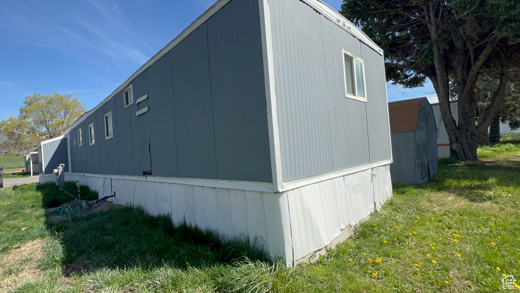 View of property exterior with a yard