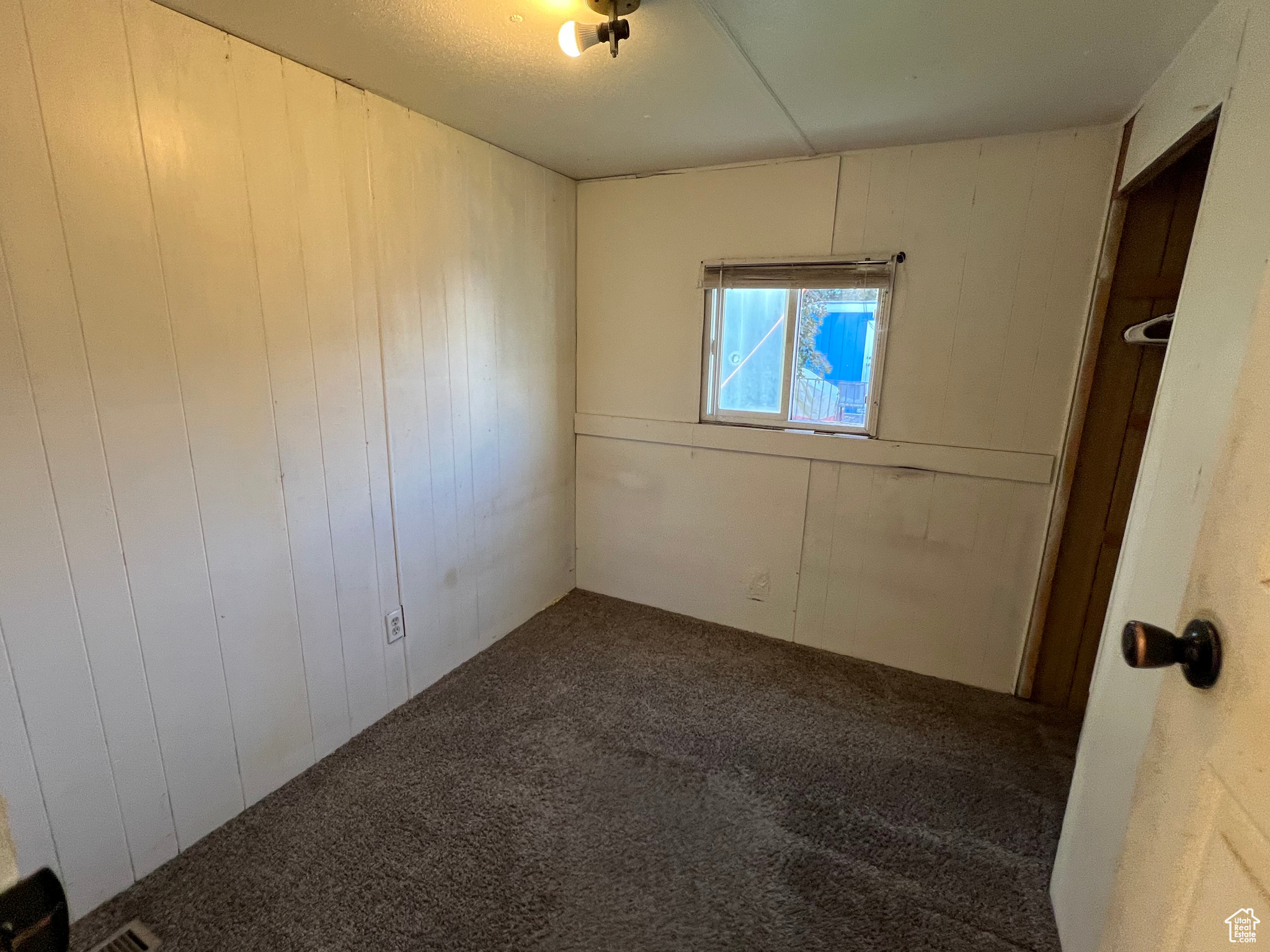 Empty room with carpet flooring