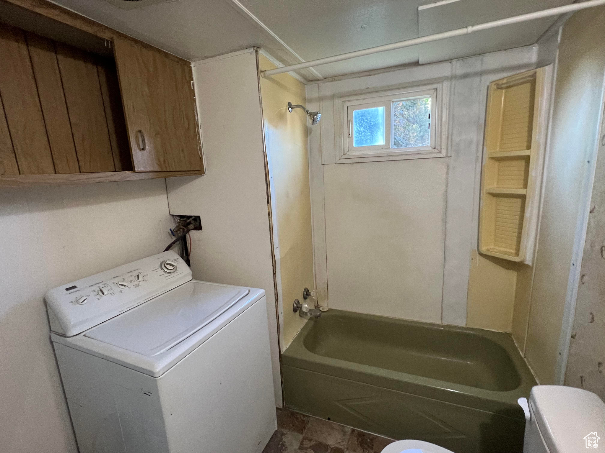 Laundry area with tile floors and washer / dryer