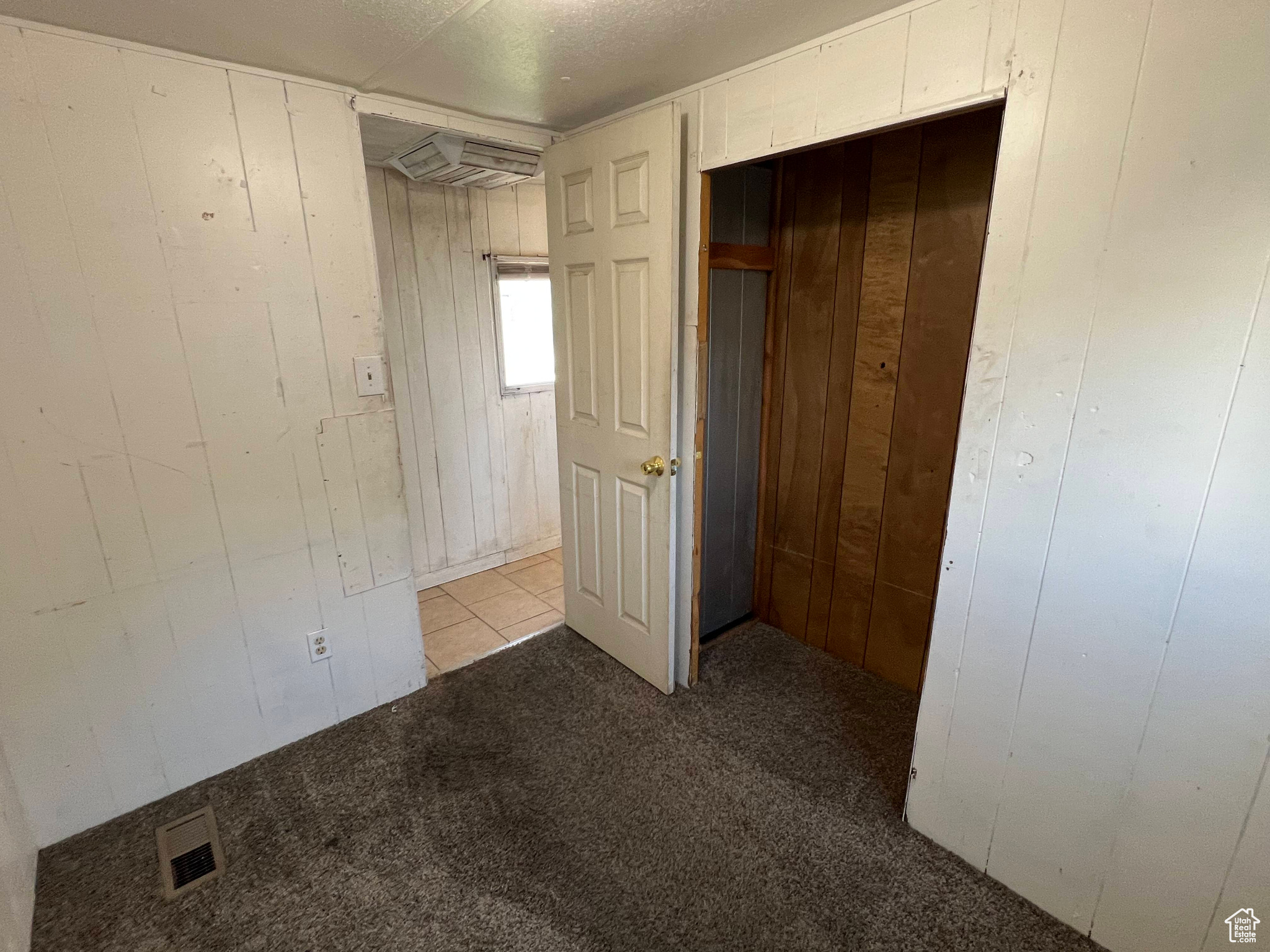 Unfurnished bedroom featuring a closet and tile floors