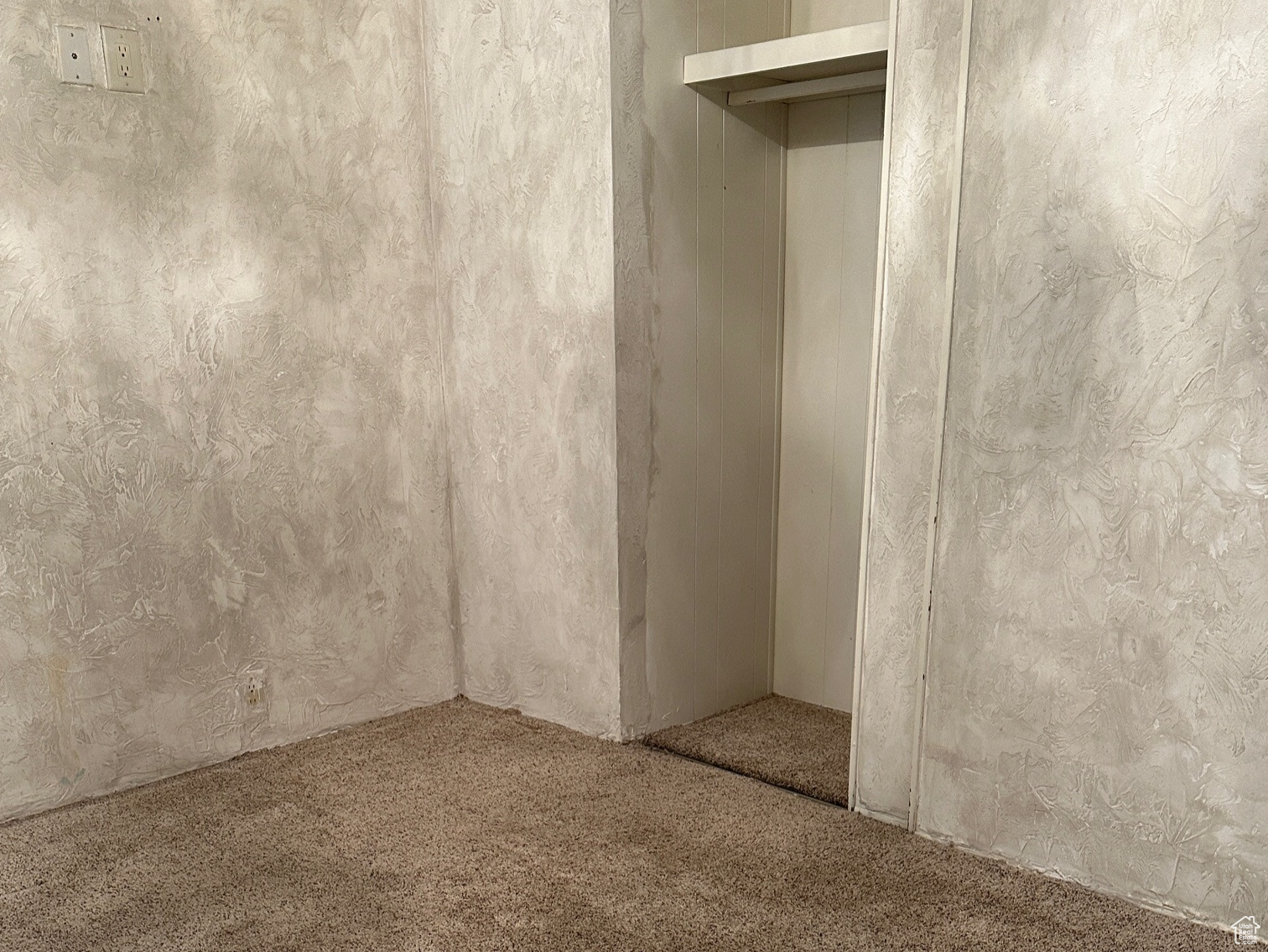 Unfurnished bedroom with a closet and carpet flooring