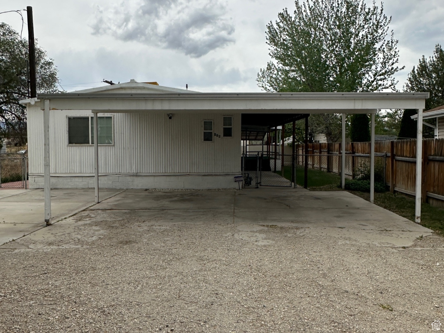 Rear view of property featuring a carport