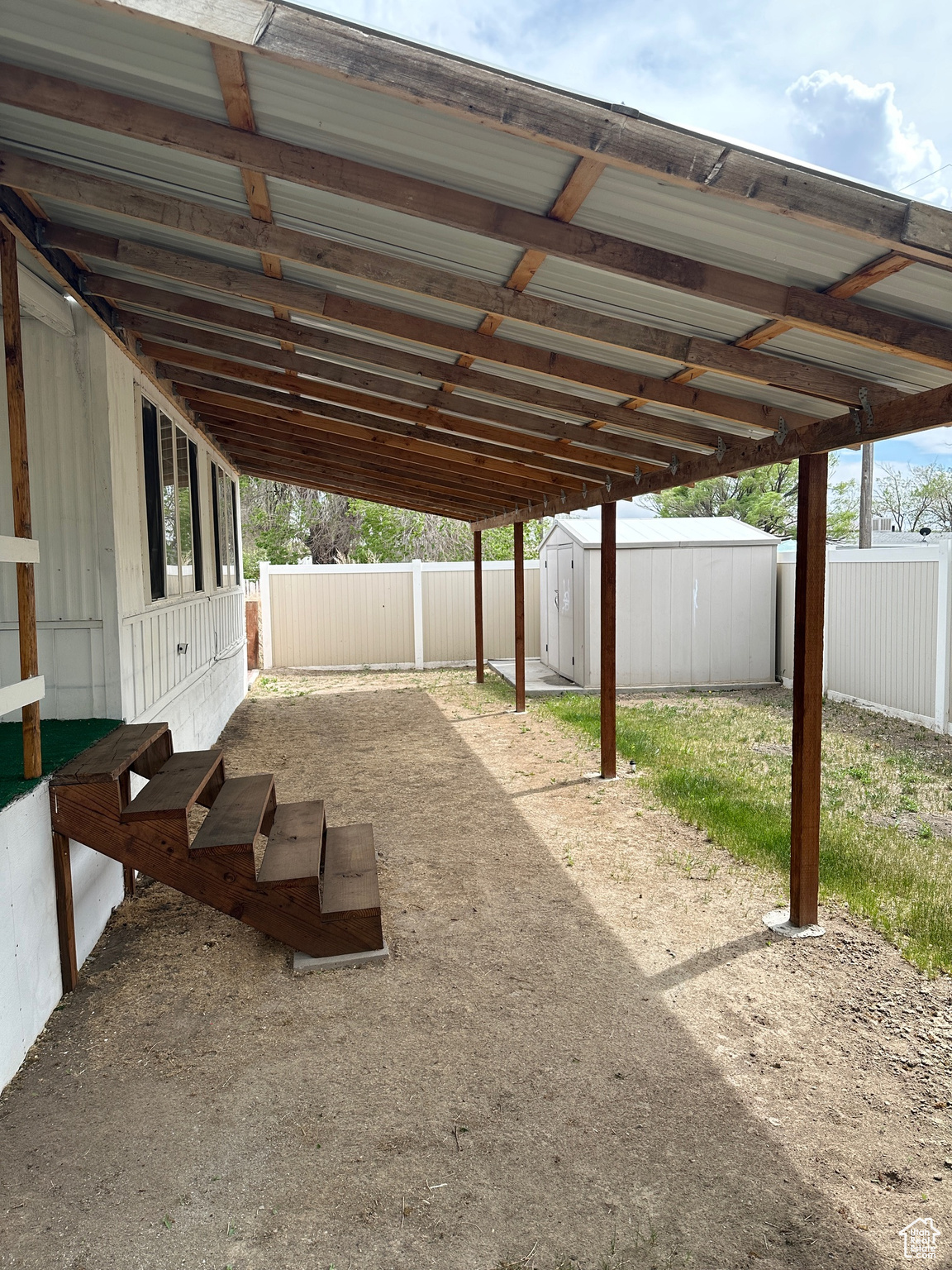 View of patio / terrace with a carport and a shed