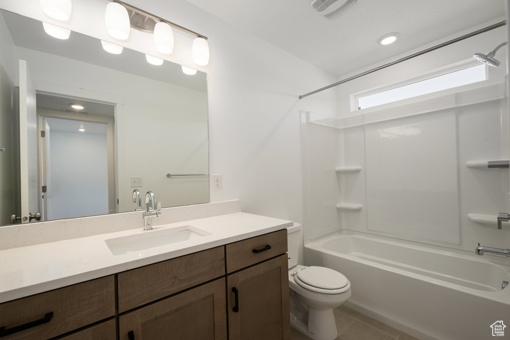 Full bathroom with bathtub / shower combination, toilet, tile patterned flooring, and vanity