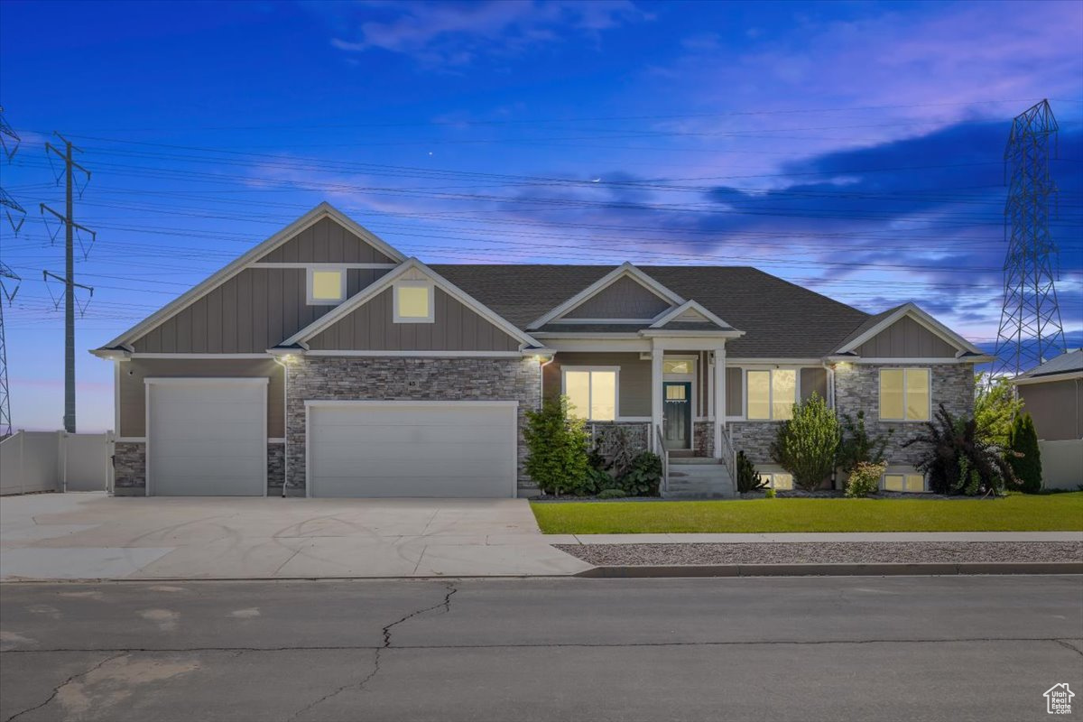 Craftsman house featuring a garage and a yard