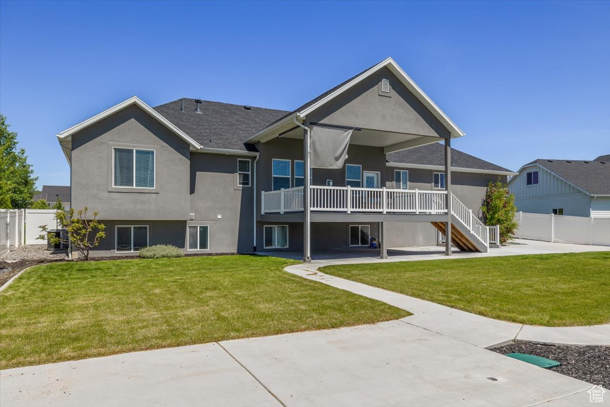 Rear view of house featuring a lawn