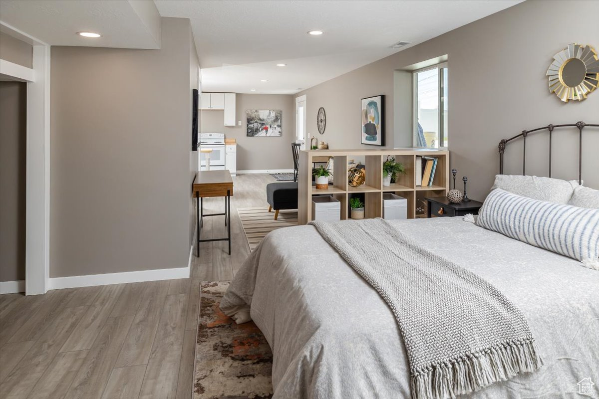 Bedroom with hardwood / wood-style flooring