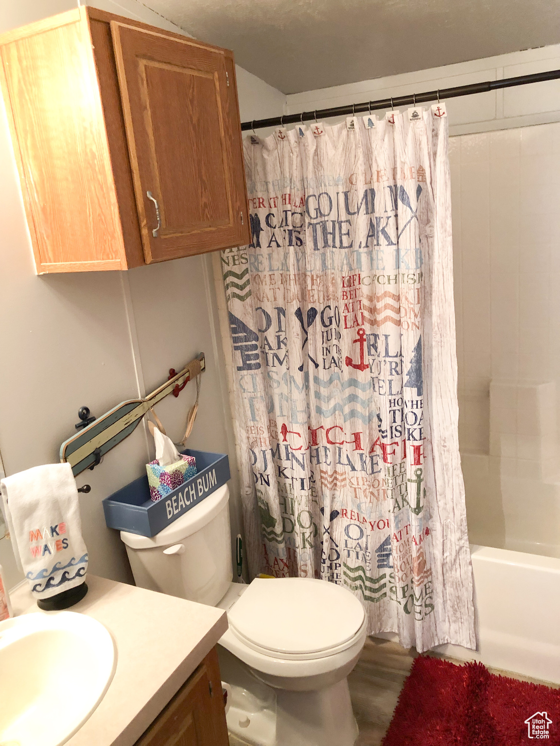 Main Full bathroom featuring shower / bathtub combination with curtain, wood-type flooring, vanity, and toilet