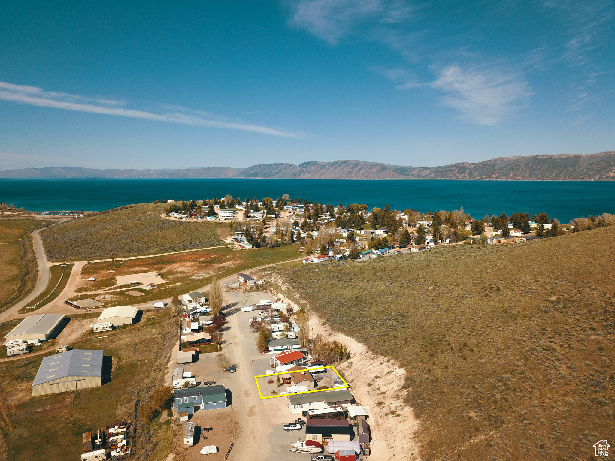 Drone / aerial view featuring the lake just over the hill and a mountain view