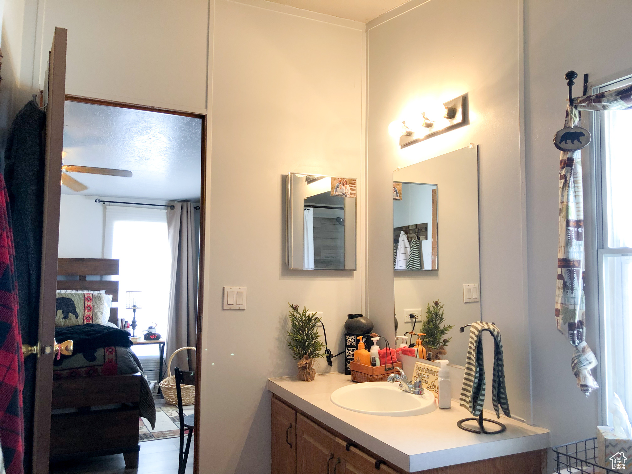 Primary Bathroom with ceiling fan and vanity