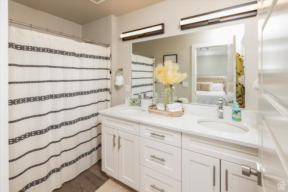 Bathroom with wood-type flooring and double sink vanity