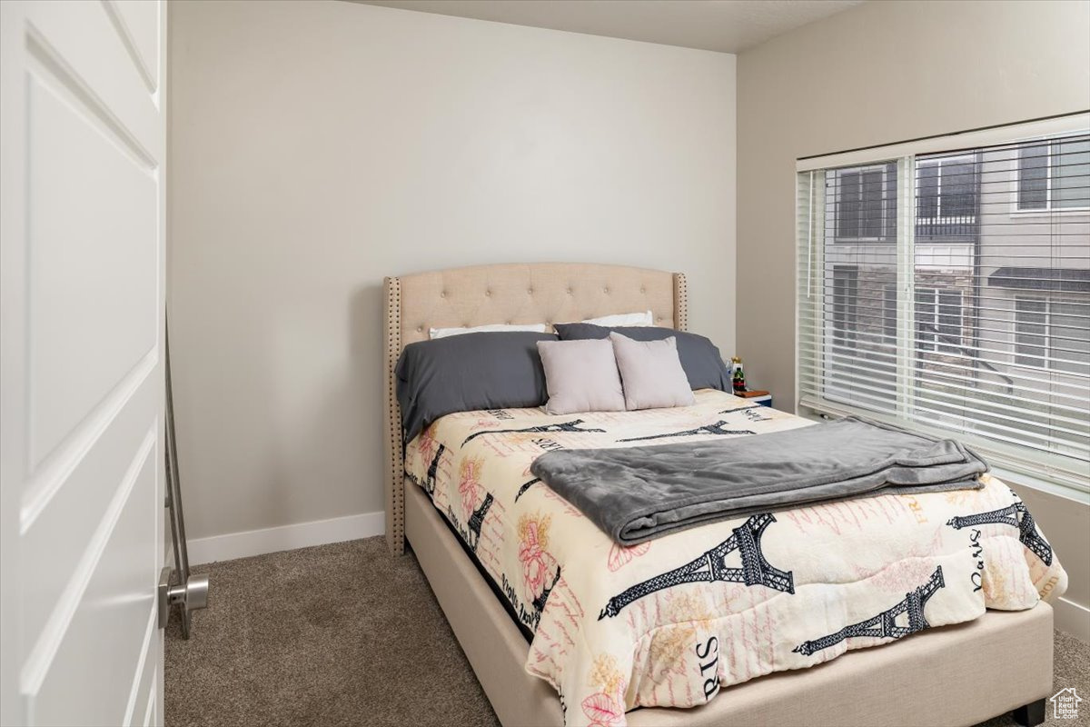 Bedroom featuring dark carpet